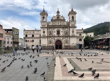 The Roman Catholic Church of Santa María de los Dolores (Saint Mary of the Sorrows) in Tegucigalpa, the capital of Honduras, was built between 1732 and 1815 in the American Baroque (Colonial Baroque) style. The Christ at El Picacho is a monument on the hill El Picacho in the north area of Tegucigalpa, the capital of Honduras. The sculpture weighs 2,500 tons and is 30 m (98 ft) high; it was completed in 1998 and can be seen from most parts of Tegucigalpa. Entrance with carvings at a Mayan archaeological site in Copán in western Honduras. The site functioned as the political, civil, and religious center of the Copán Valley and was composed of a main complex with several secondary complexes. Copán was declared a UNESCO World Heritage Site in 1980. Roatán is an island in the Caribbean, about 65 km (40 mi) off the northern coast of Honduras. The largest of the Bay Islands, it is approximately 77 km (48 mi) long and less than 8 km (5 mi) wide. The island rests on an exposed ancient coral reef, offering opportunities for diving. Roatán is located near the Mesoamerican Barrier Reef, the largest barrier reef in the Caribbean Sea, and has become a major tourist destination.